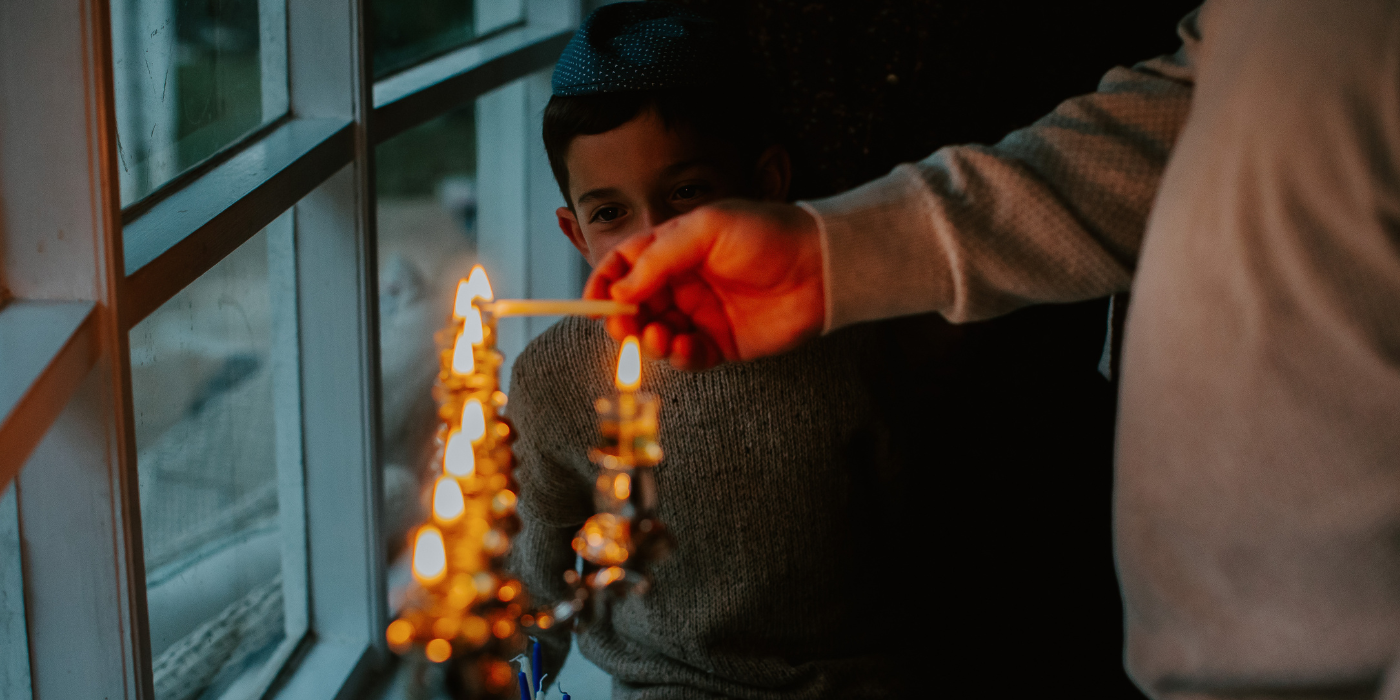 family lighting menorah 