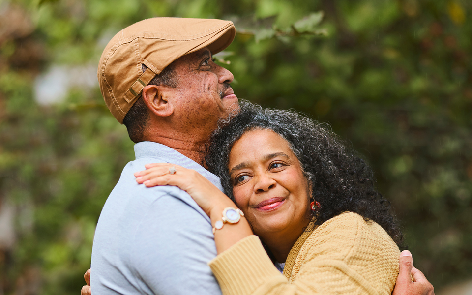 Older couple embracing affectionately outdoors