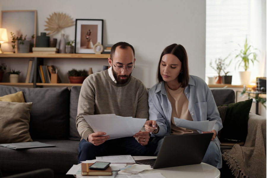 Man and women looking at paperwork and computer
