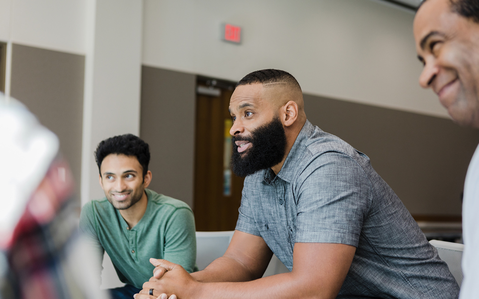 Men participating in a group discussion or support meeting