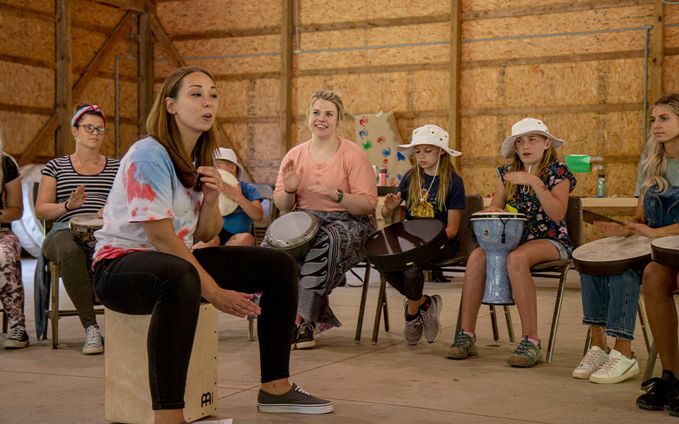 Group drumming activity with adults and children participating in a community workshop