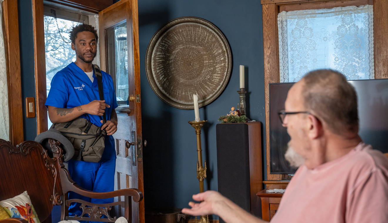 Male nurse entering male patients home 