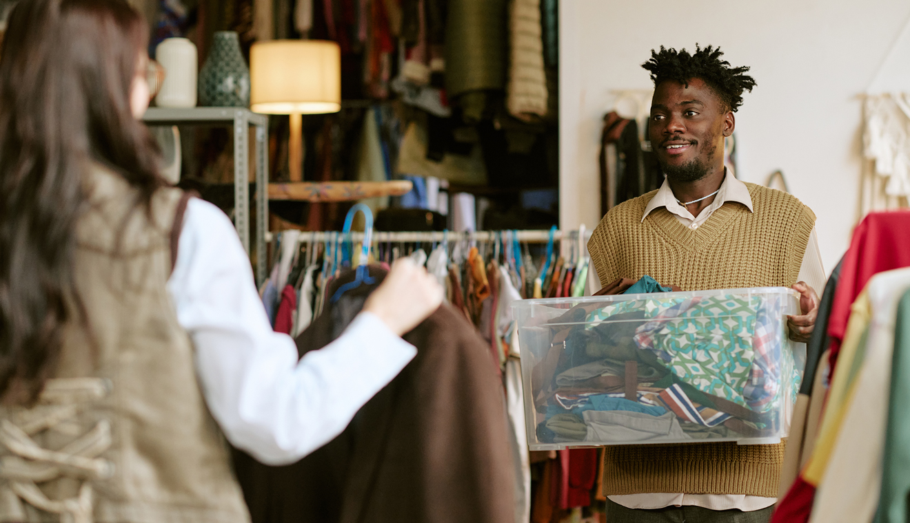 Two people organizing clothing inside a store