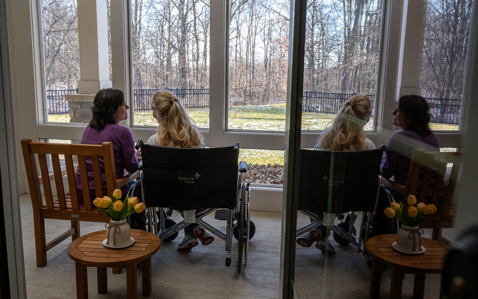 People setting in front of window talking